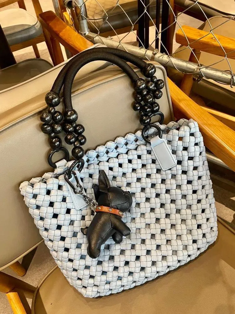 XIEYINSHE 2025 women's bags, large-capacity vegetable baskets, woven tote bags, portable high-grade hollow wooden beads, wrist and mother shoulder bags.