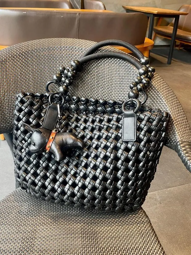 XIEYINSHE 2025 women's bags, large-capacity vegetable baskets, woven tote bags, portable high-grade hollow wooden beads, wrist and mother shoulder bags.